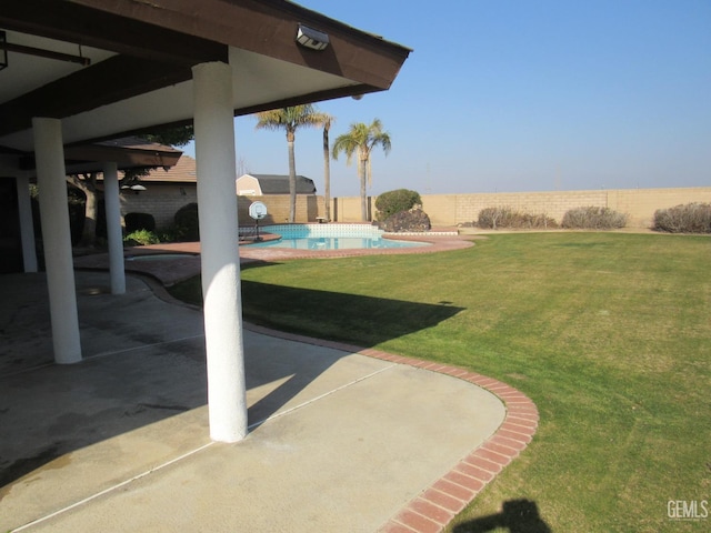 view of yard with a fenced in pool and a patio