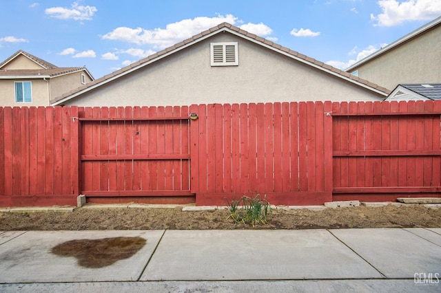 view of property exterior with fence and stucco siding