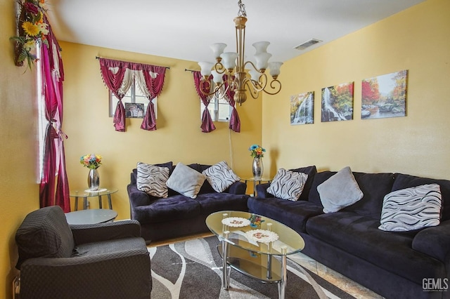 living room featuring carpet floors, visible vents, and a notable chandelier