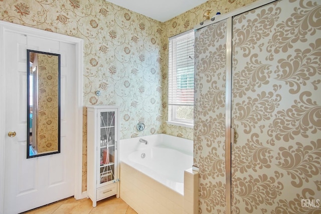 full bath with tile patterned floors, a garden tub, and wallpapered walls