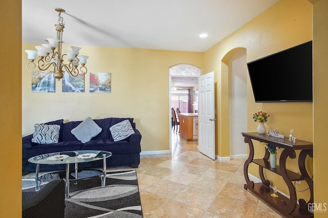 living room featuring recessed lighting, baseboards, and an inviting chandelier