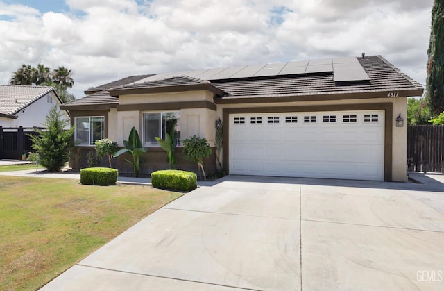4811 Council Bluffs Ct, Bakersfield, CA 93311 - view of front of house featuring solar panels, stucco siding, concrete driveway, a garage, and a tile roof