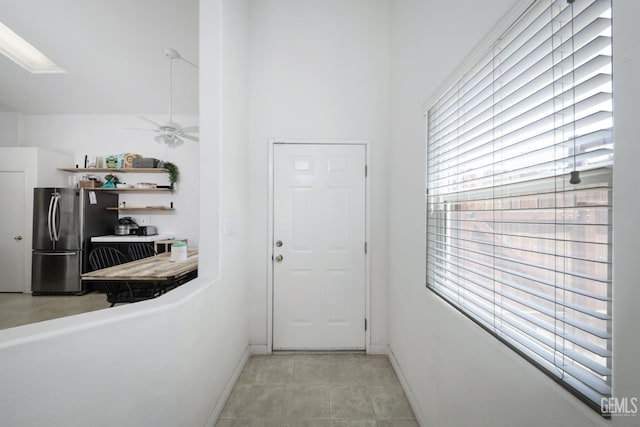 4811 Council Bluffs Ct, Bakersfield, CA 93311 - doorway to outside featuring ceiling fan, light tile patterned floors, and a skylight