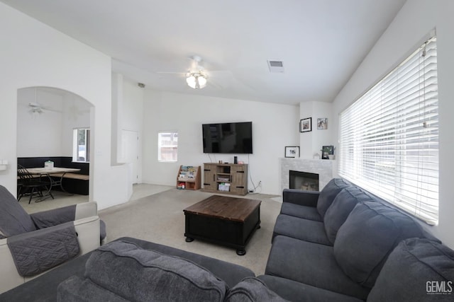 4811 Council Bluffs Ct, Bakersfield, CA 93311 - carpeted living area featuring ceiling fan, lofted ceiling, a fireplace, and arched walkways