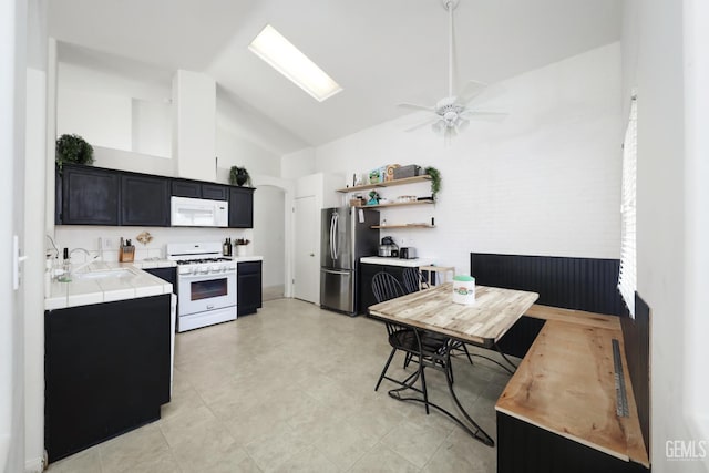 4811 Council Bluffs Ct, Bakersfield, CA 93311 - kitchen with white appliances, dark cabinets, ceiling fan, tile counters, and open shelves