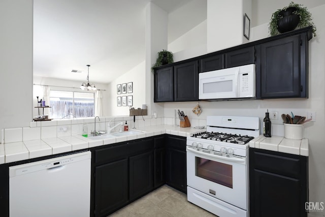 4811 Council Bluffs Ct, Bakersfield, CA 93311 - kitchen featuring white appliances, a chandelier, lofted ceiling, dark cabinetry, and tile countertops