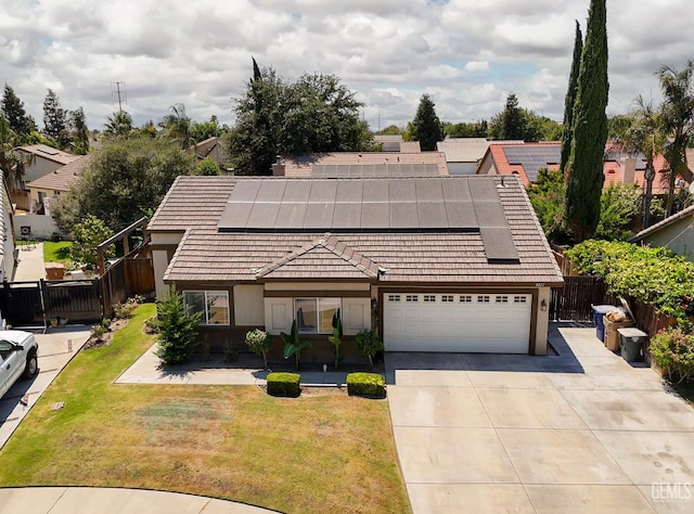 4811 Council Bluffs Ct, Bakersfield, CA 93311 - view of front of home featuring driveway, solar panels, a tile roof, and stucco siding
