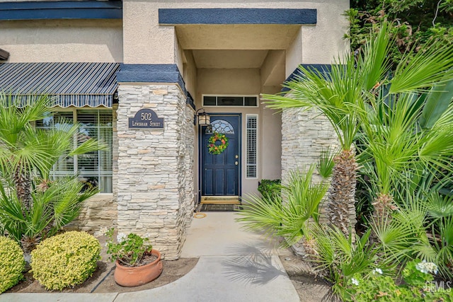 502 Lewisham St, Bakersfield, CA 93311 - doorway to property featuring stone siding and stucco siding