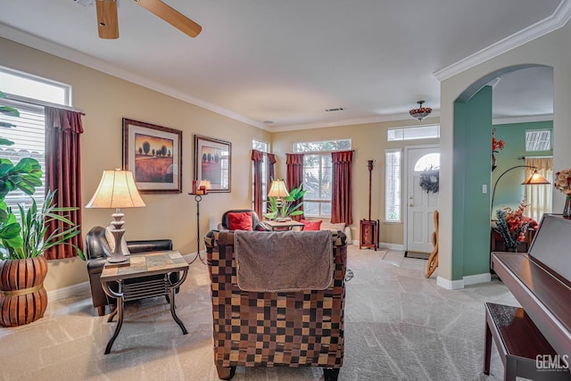 502 Lewisham St, Bakersfield, CA 93311 - living area featuring arched walkways, light colored carpet, baseboards, ceiling fan, and plenty of natural light