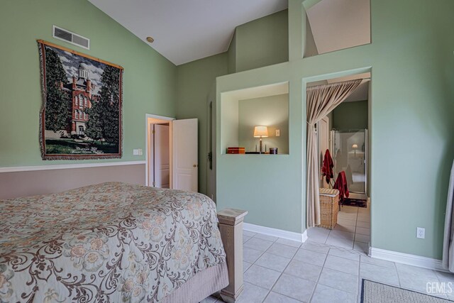 502 Lewisham St, Bakersfield, CA 93311 - bedroom with high vaulted ceiling, light tile patterned floors, baseboards, and ensuite bathroom