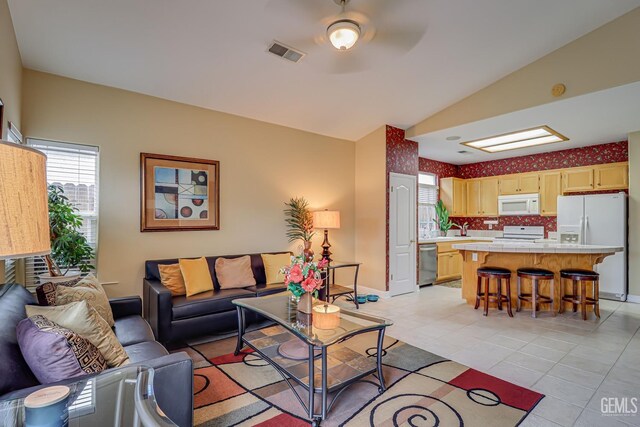502 Lewisham St, Bakersfield, CA 93311 - living area with light tile patterned floors, vaulted ceiling, and baseboards
