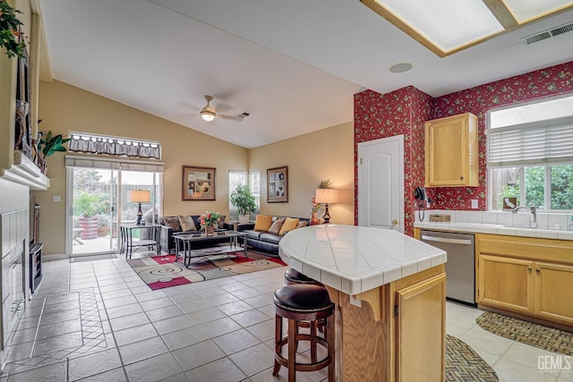 502 Lewisham St, Bakersfield, CA 93311 - kitchen with dishwasher, tile countertops, a ceiling fan, a sink, and vaulted ceiling