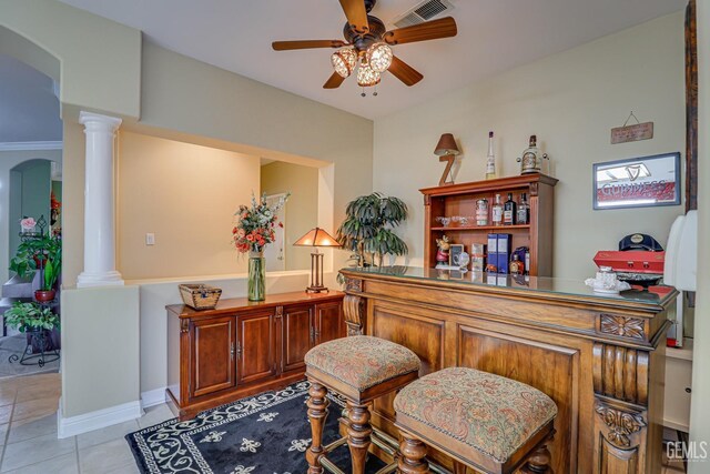 502 Lewisham St, Bakersfield, CA 93311 - bar area with a ceiling fan, decorative columns, light tile patterned flooring, and arched walkways