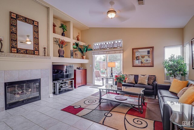 502 Lewisham St, Bakersfield, CA 93311 - living area with vaulted ceiling, ceiling fan, a fireplace, and light tile patterned floors