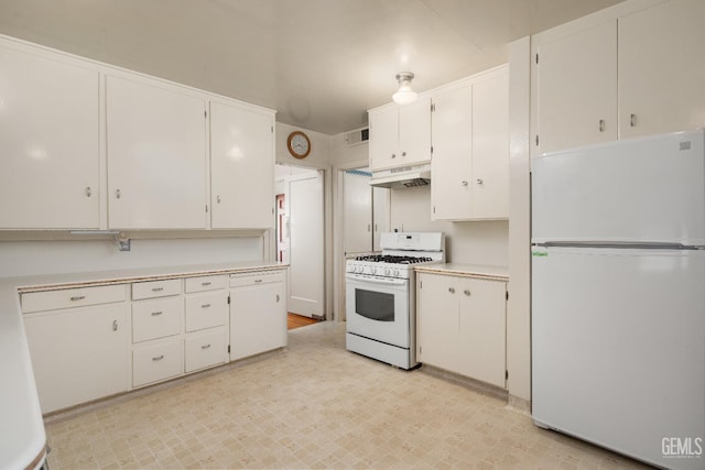 kitchen with white cabinets, white appliances, and custom range hood