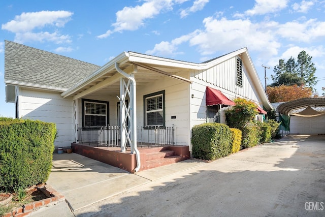 view of front of property with a porch and an outbuilding