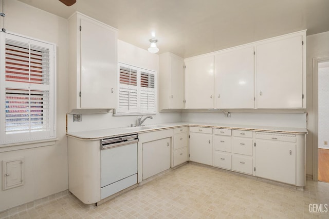 kitchen featuring dishwasher, white cabinetry, and sink