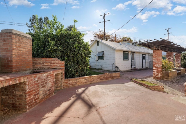 rear view of house with a pergola and a patio