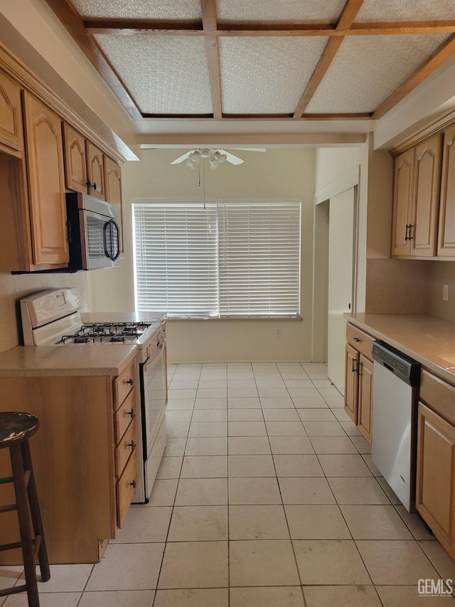 kitchen featuring appliances with stainless steel finishes, ceiling fan, and light tile patterned floors