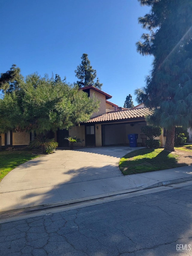 view of front of home with a front lawn and a garage