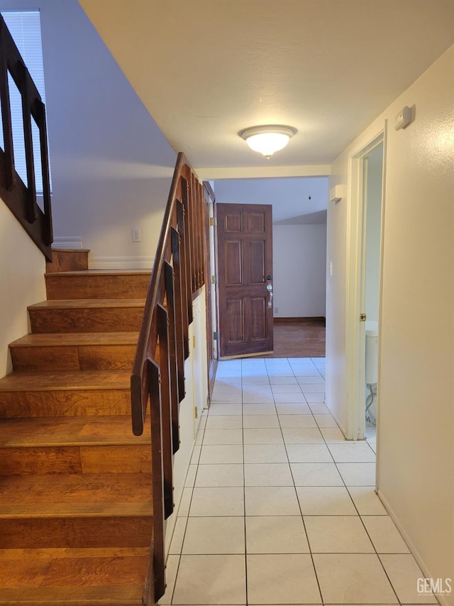 stairway with tile patterned flooring