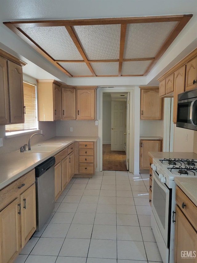 kitchen featuring stainless steel appliances, light brown cabinets, sink, and light tile patterned floors