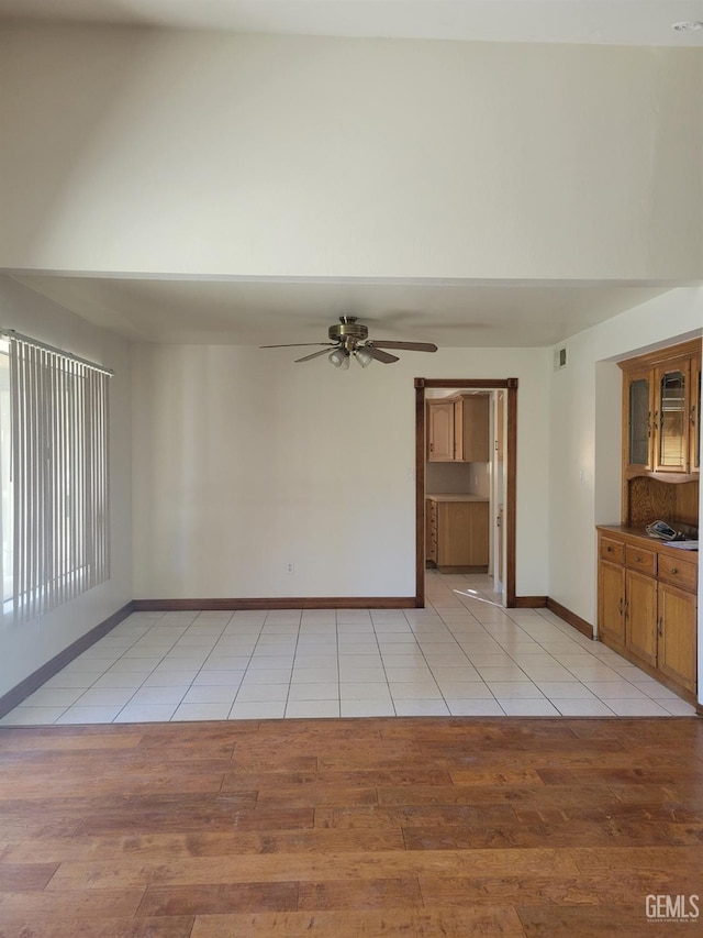 unfurnished room with ceiling fan and light hardwood / wood-style floors