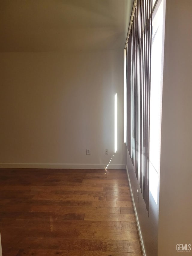 empty room featuring dark hardwood / wood-style flooring