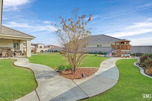 view of yard with a patio and a playground