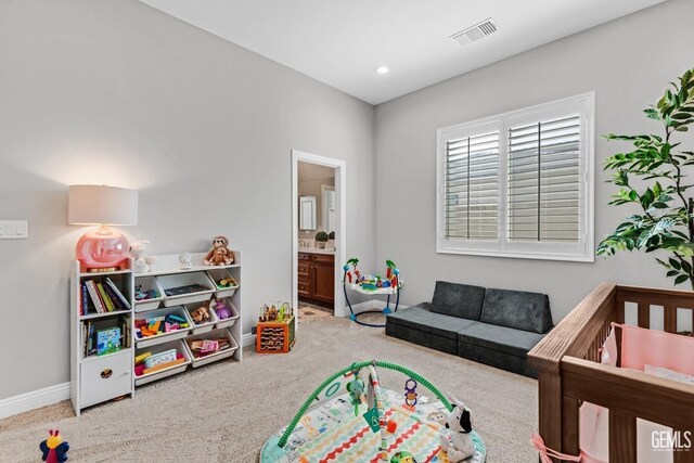 bedroom featuring a crib and carpet flooring