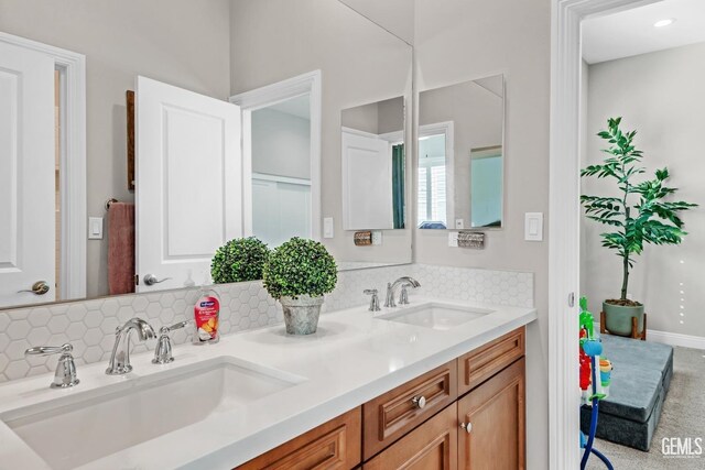 bathroom with decorative backsplash and vanity