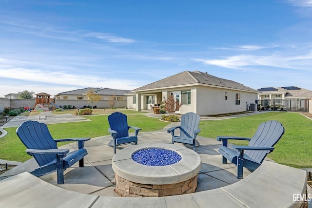 view of patio / terrace with a playground, a fire pit, and cooling unit