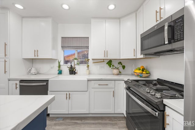 21633 Golden Hills Blvd, Tehachapi, CA 93561 - kitchen with appliances with stainless steel finishes, recessed lighting, white cabinets, and light stone counters