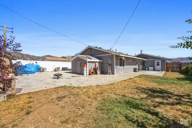 21633 Golden Hills Blvd, Tehachapi, CA 93561 - back of house with a patio area, a shed, a fenced backyard, and an outdoor fire pit