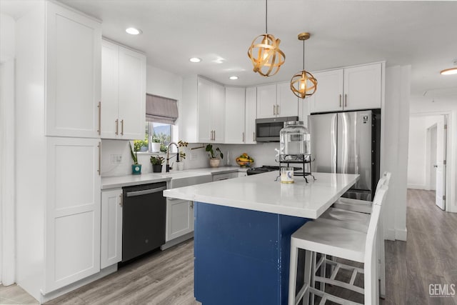 21633 Golden Hills Blvd, Tehachapi, CA 93561 - kitchen with appliances with stainless steel finishes, light wood finished floors, recessed lighting, light countertops, and white cabinetry