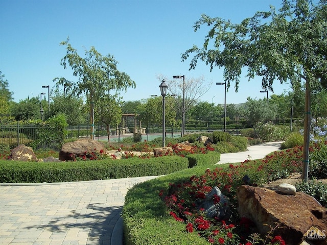 view of home's community featuring tennis court