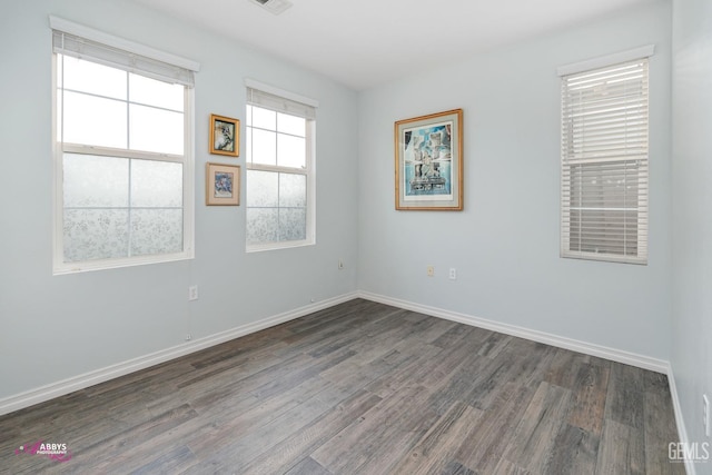 unfurnished room featuring dark wood-type flooring