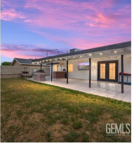 337 Cesar Chavez Ln, Delano, CA 93215 - rear view of house featuring a patio area, french doors, and stucco siding