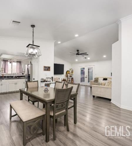 337 Cesar Chavez Ln, Delano, CA 93215 - dining room featuring ornamental molding, light wood-type flooring, recessed lighting, a chandelier, and french doors