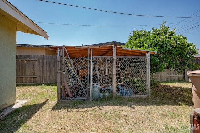 view of outdoor structure featuring an outbuilding and a fenced backyard