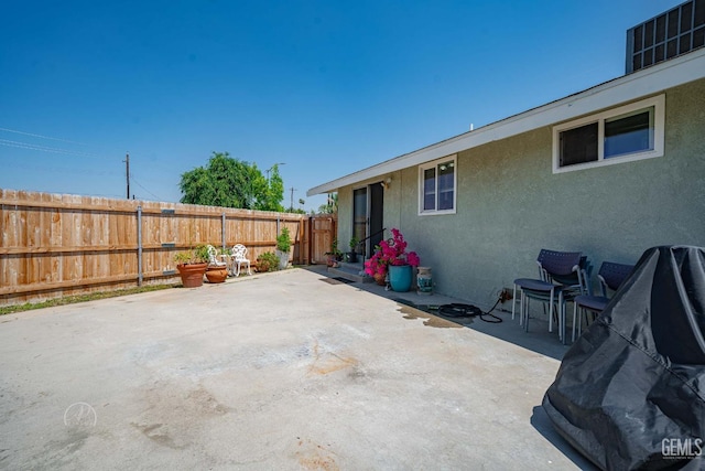view of patio / terrace featuring fence