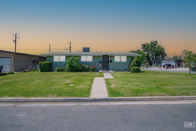 view of front of home with fence and a front lawn