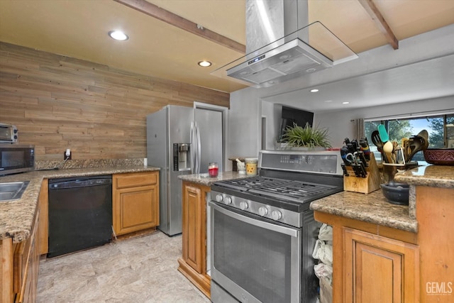 kitchen with recessed lighting, wooden walls, appliances with stainless steel finishes, wall chimney range hood, and brown cabinets