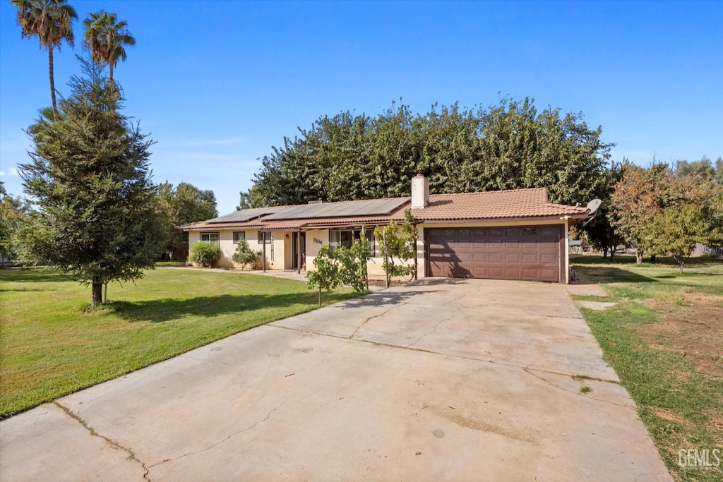 7504 Whirlaway St, Bakersfield, CA 93307 - ranch-style home with a chimney, solar panels, concrete driveway, an attached garage, and a front lawn