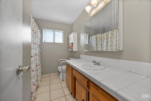 full bath with toilet, a shower with curtain, vanity, and tile patterned floors