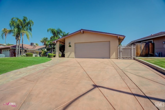 view of front of property with a garage and a front lawn