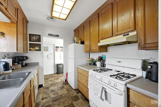 kitchen featuring white appliances and sink