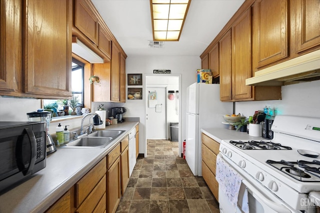 kitchen featuring sink and white appliances