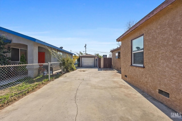 view of side of home with a garage and an outdoor structure