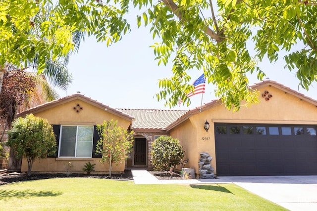 view of front of house with a front yard and a garage